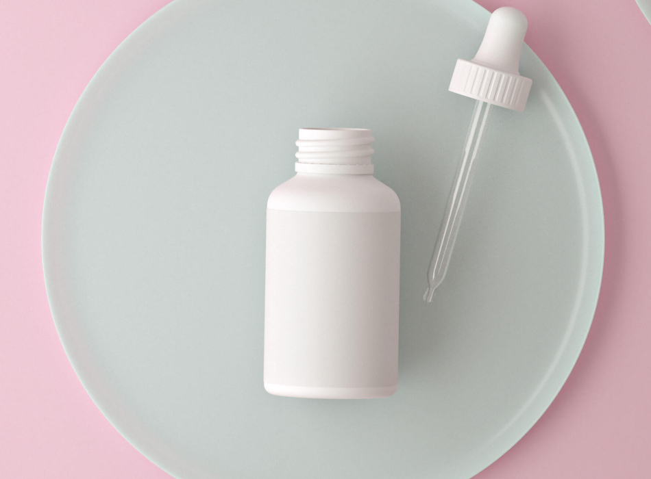 White plastic dropper bottle on a pastel background, representing a topical minoxidil product.